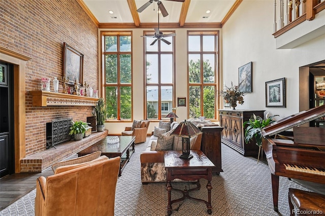 5475 S Laredo St, Centennial, CO 80015 - living area with a towering ceiling, ceiling fan, beamed ceiling, crown molding, and a fireplace