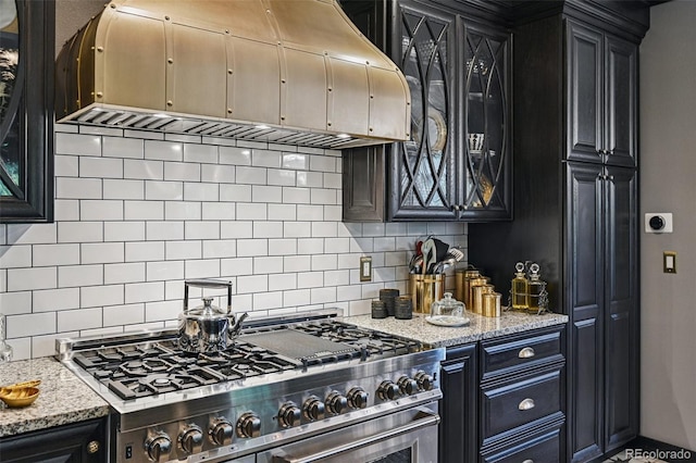 5475 S Laredo St, Centennial, CO 80015 - kitchen with high end range, custom range hood, backsplash, and dark cabinets