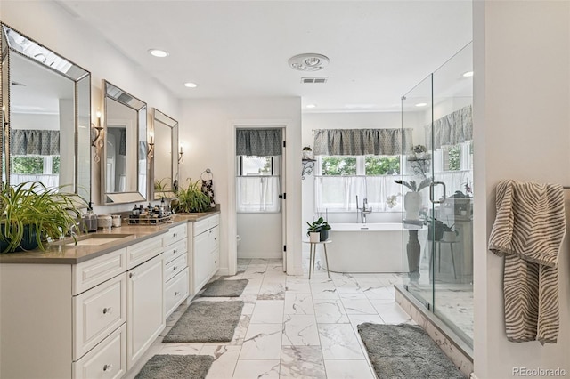5475 S Laredo St, Centennial, CO 80015 - bathroom with a freestanding bath, double vanity, marble look tiles, recessed lighting, and an enclosed shower