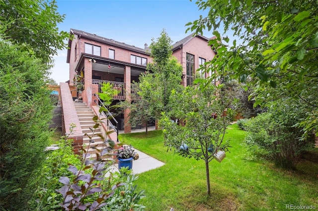 5475 S Laredo St, Centennial, CO 80015 - back of property featuring a lawn, stairs, and brick siding