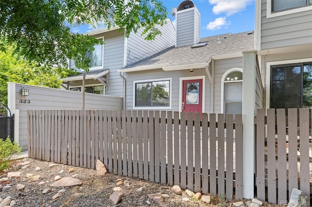 323 S Taft Ct Unit 26, Louisville, CO 80027 - view of front facade with a chimney and a shingled roof