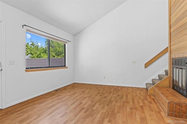 323 S Taft Ct Unit 26, Louisville, CO 80027 - empty room with vaulted ceiling, wood finished floors, and stairs