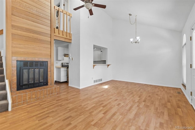 323 S Taft Ct Unit 26, Louisville, CO 80027 - unfurnished living room featuring high vaulted ceiling, light wood finished floors, a ceiling fan, a chandelier, and stairway