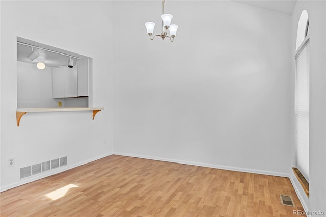 323 S Taft Ct Unit 26, Louisville, CO 80027 - unfurnished dining area with light wood-style floors, track lighting, and a chandelier