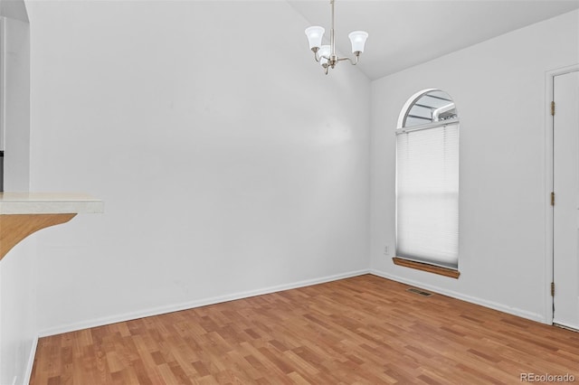 323 S Taft Ct Unit 26, Louisville, CO 80027 - unfurnished dining area with light wood-style floors, lofted ceiling, and a chandelier