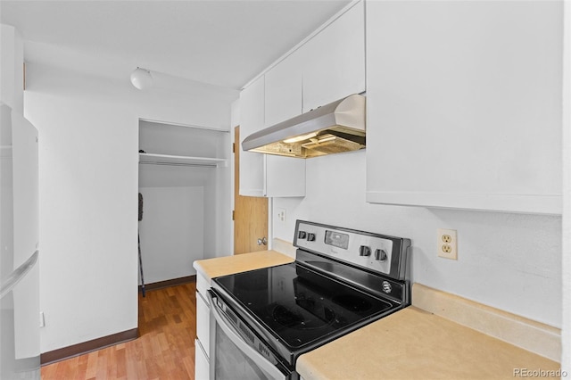 323 S Taft Ct Unit 26, Louisville, CO 80027 - kitchen featuring stainless steel electric range oven, extractor fan, white cabinets, freestanding refrigerator, and light countertops