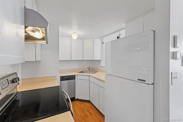 323 S Taft Ct Unit 26, Louisville, CO 80027 - kitchen featuring freestanding refrigerator, electric range, dishwasher, and white cabinetry