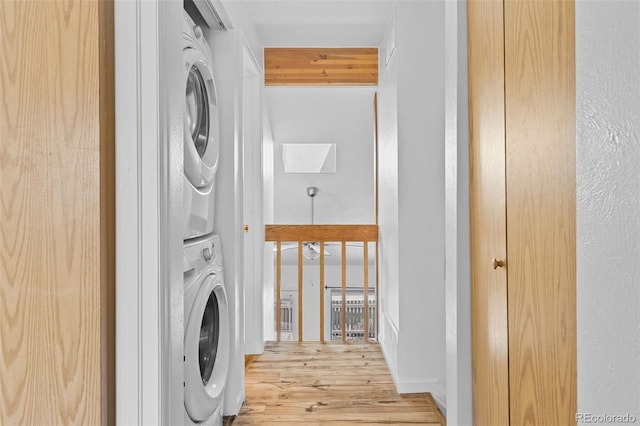 323 S Taft Ct Unit 26, Louisville, CO 80027 - washroom featuring stacked washing machine and dryer and wood finished floors