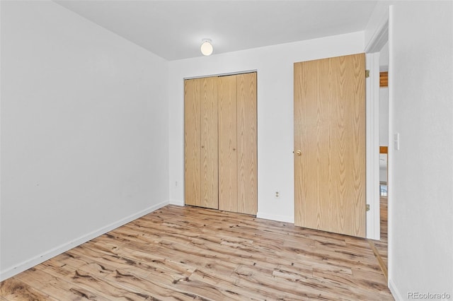 323 S Taft Ct Unit 26, Louisville, CO 80027 - unfurnished bedroom featuring wood finished floors and a closet