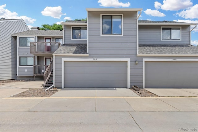 323 S Taft Ct Unit 26, Louisville, CO 80027 - view of property featuring a garage, concrete driveway, a balcony, and roof with shingles