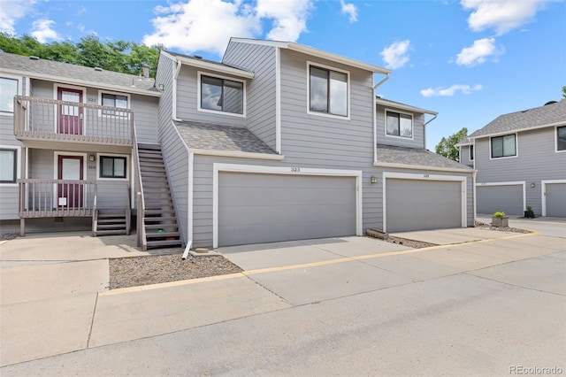 323 S Taft Ct Unit 26, Louisville, CO 80027 - view of property with an attached garage, stairway, concrete driveway, and a shingled roof