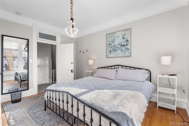 bedroom featuring crown molding and wood-type flooring