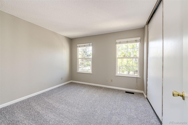 8231 S Fillmore Way, Centennial, CO 80122 - carpeted empty room featuring baseboards and a textured ceiling