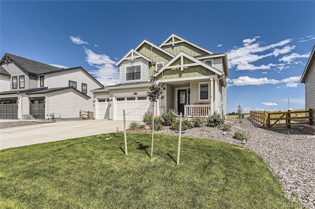 craftsman house with driveway, an attached garage, covered porch, fence, and board and batten siding