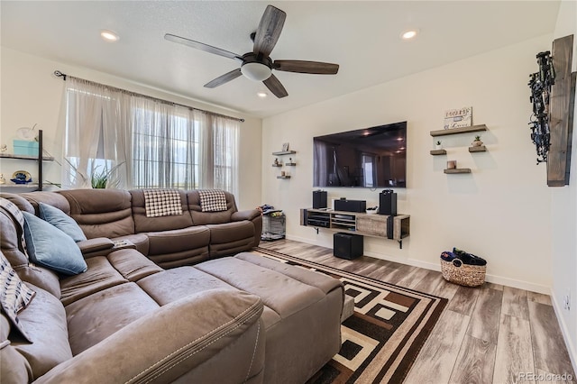 living area featuring baseboards, wood finished floors, a ceiling fan, and recessed lighting