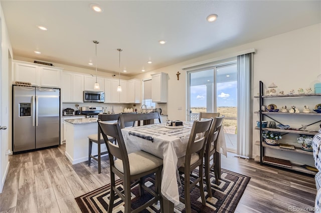 dining room featuring recessed lighting and wood finished floors