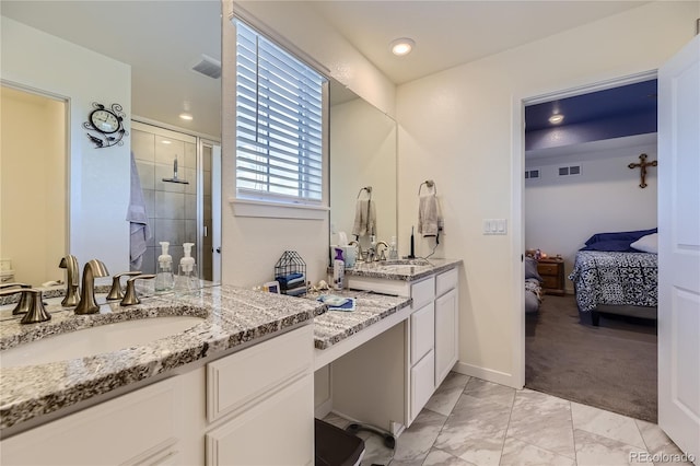 ensuite bathroom with marble finish floor, visible vents, a sink, and a shower stall