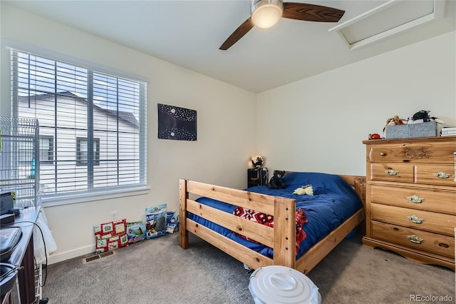 bedroom featuring ceiling fan, carpet floors, visible vents, and attic access