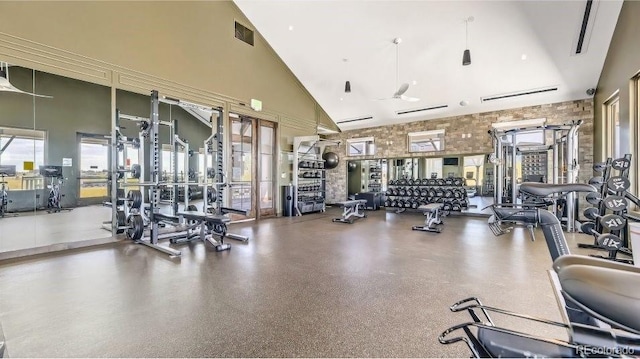 workout area featuring visible vents and a high ceiling