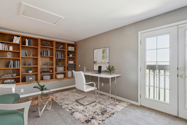 carpeted office featuring attic access, baseboards, and plenty of natural light