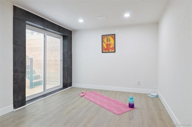 workout area featuring plenty of natural light, wood finished floors, and baseboards