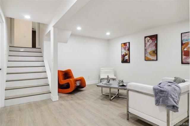 sitting room with light wood finished floors, stairs, baseboards, and recessed lighting