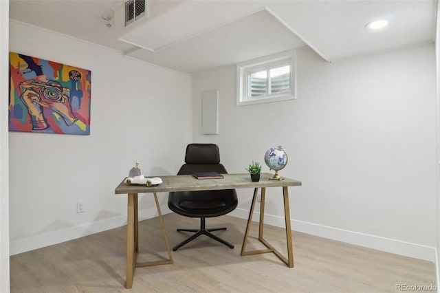 office with baseboards, light wood finished floors, and visible vents
