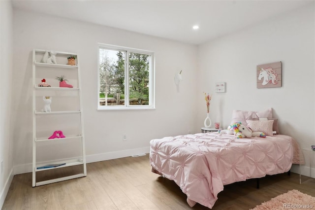 bedroom with recessed lighting, baseboards, and wood finished floors