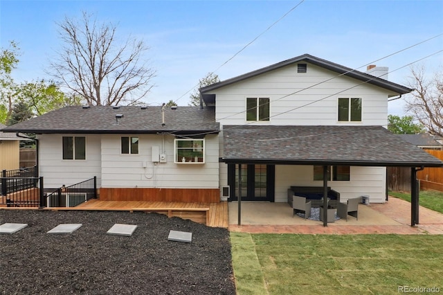 back of house featuring an outdoor living space, a patio, roof with shingles, and fence