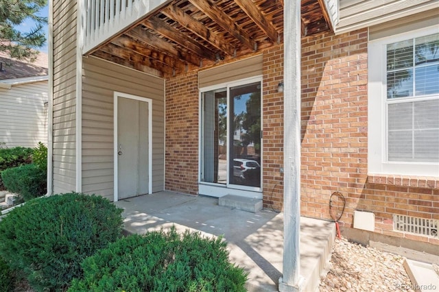 4656 S Dillon Ct Unit D, Aurora, CO 80015 - doorway to property featuring brick siding