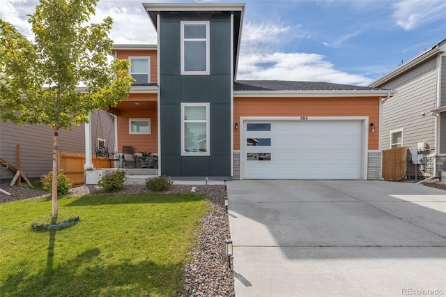 view of front of home with a front yard, an attached garage, driveway, and fence