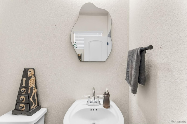 bathroom with a sink and a textured wall