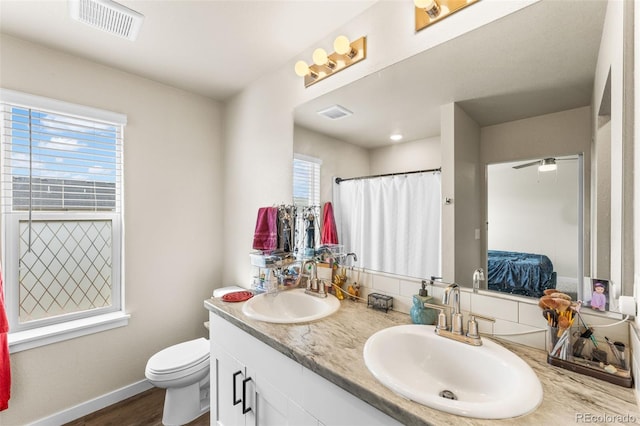 ensuite bathroom with plenty of natural light, visible vents, ensuite bathroom, and a sink