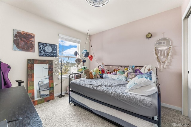 bedroom with carpet flooring and baseboards