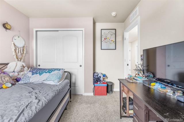 carpeted bedroom with baseboards, visible vents, and a closet