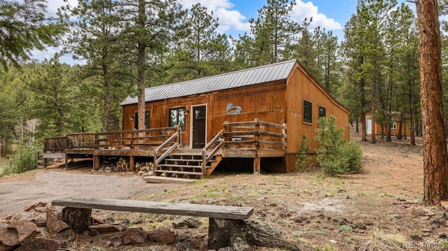 3763 County Road 43, Bailey, CO 80421 - view of front facade featuring a metal roof and a wooden deck