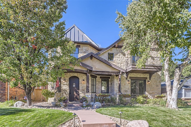 view of front of property with a balcony and a front yard