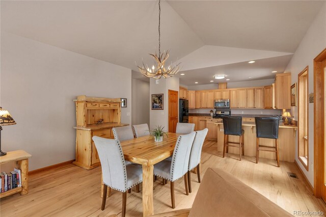 dining area with light wood finished floors, a chandelier, recessed lighting, vaulted ceiling, and visible vents