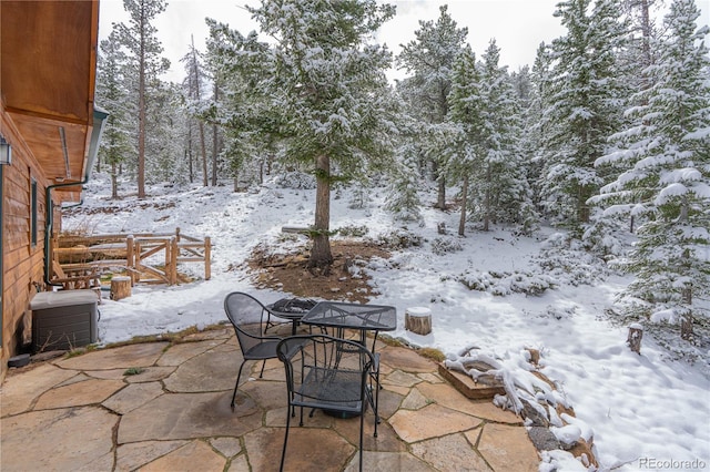 snow covered patio featuring outdoor dining area