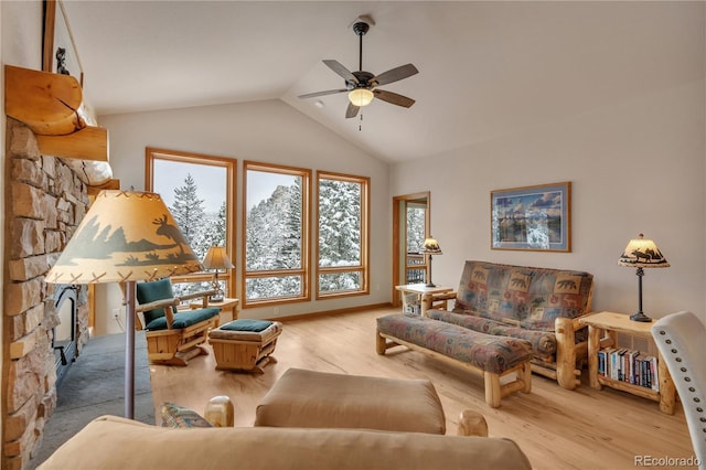 living area featuring ceiling fan, wood finished floors, and lofted ceiling