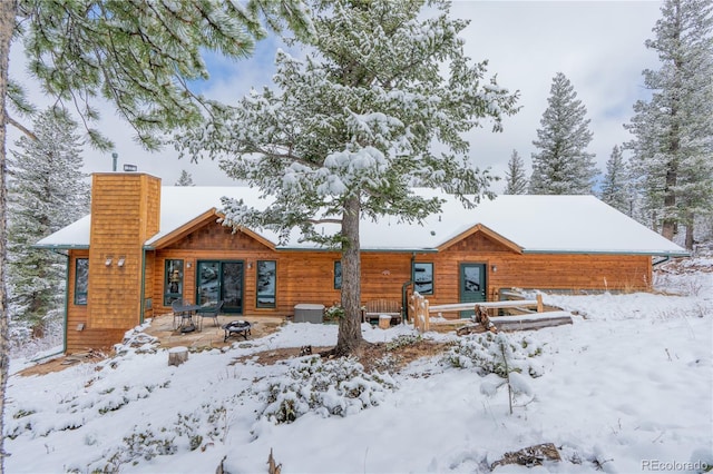 snow covered house with a chimney