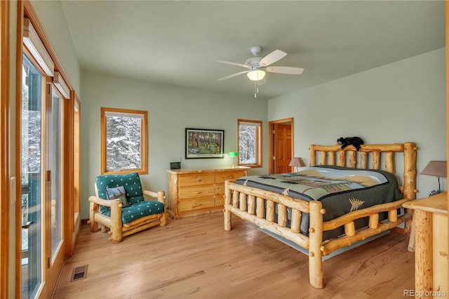 bedroom with ceiling fan, light wood-style flooring, and visible vents