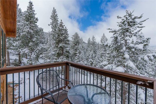 view of snow covered back of property