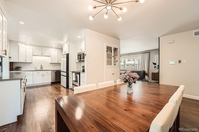 1465 S Urban Way, Lakewood, CO 80228 - dining room with recessed lighting, a chandelier, dark wood-style floors, and visible vents