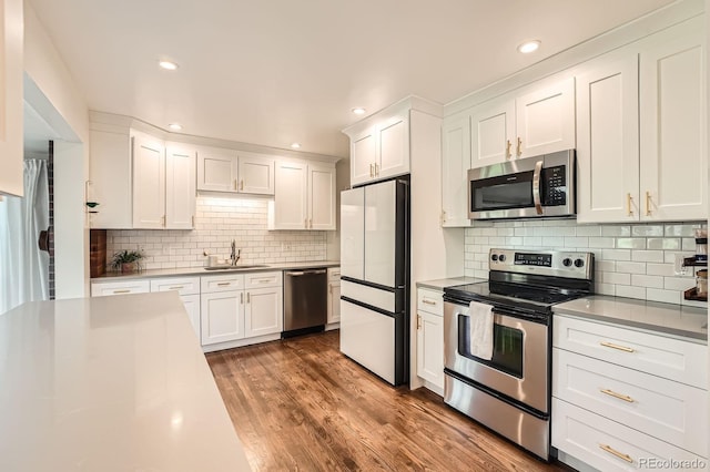 1465 S Urban Way, Lakewood, CO 80228 - kitchen featuring a sink, white cabinets, and stainless steel appliances