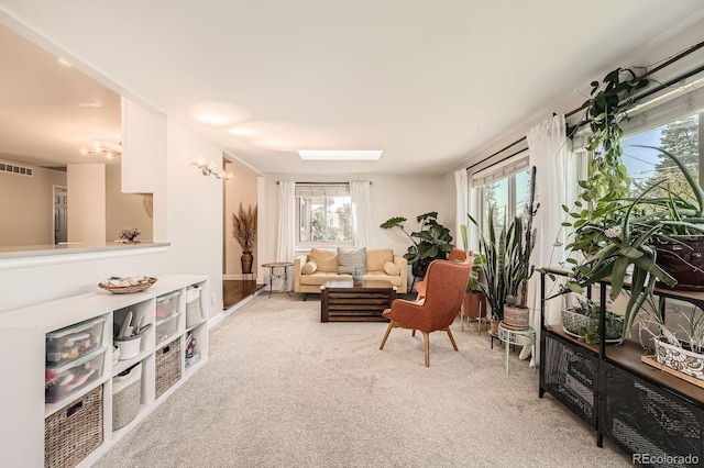 1465 S Urban Way, Lakewood, CO 80228 - living area with carpet flooring, a skylight, visible vents, and a wealth of natural light
