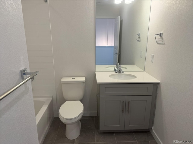 bathroom featuring toilet, tile patterned floors, baseboards, and vanity