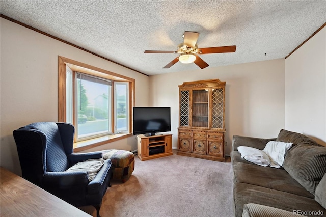 living area with ceiling fan, a textured ceiling, and light colored carpet