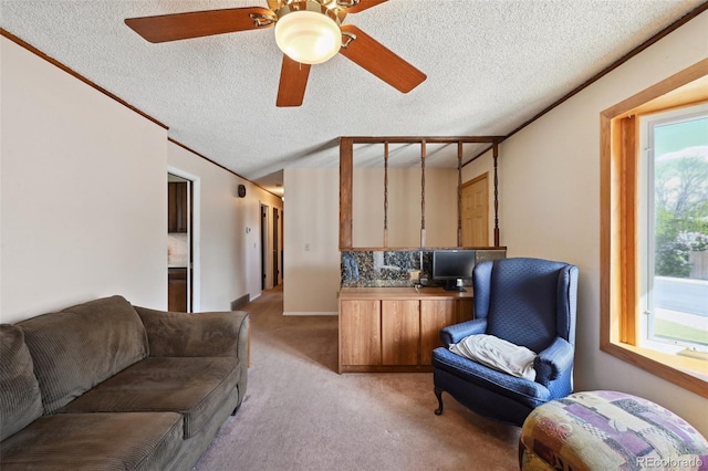 interior space featuring a textured ceiling, light carpet, ceiling fan, and lofted ceiling