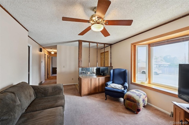 living room featuring baseboards, a ceiling fan, a textured ceiling, and light colored carpet